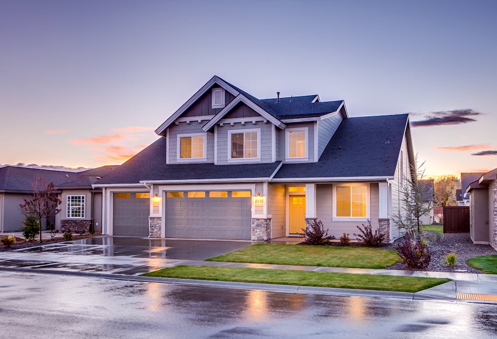 Elegant Maple Valley home with driveway at sunset showcasing modern architecture.